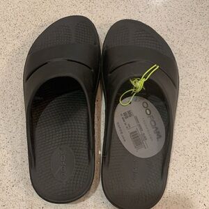 Oofos Woman’s Slides.  NWT: Color: Black, Size 8.  NWT- brand new. Never worn